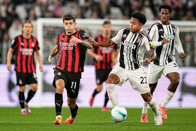 Gelandang AC Milan Christian Pulisic berebut bola dengan gelandang Juventus Weston McKennie dalam laga lanjutan Liga Italia Serie A di Stadion Allianz, Turin, Italia, Senin (6/10/2025) dini hari WIB. (X/@SerieA_EN)