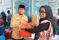 Direktur RSUD Kota Tangerang saat memberikan sembako ke masyarakat yang ikut cek kesehatan