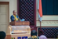 Yanyan Ruchyansyah, membacakan sambutan tertulis Gubernur Lampung saat membuka secara resmi Rapat Anggota Tahunan (RAT) Koperasi Pegawai Republik Indonesia (KPRI) Saptawa Provinsi Lampung Tahun Buku 2025 di Gedung Pusiban